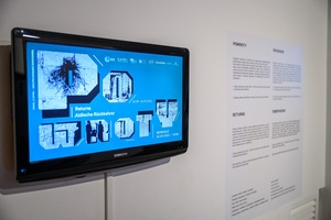 Wystawa: Powroty - Grafika do wystawy Powroty wyświetlana na telewizorze i opis wystawy.