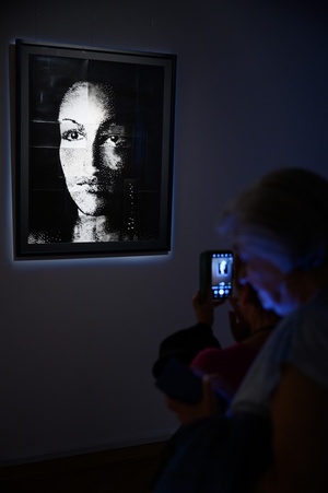 Wystawa: Tańcząc ze światłem - Publiczność wernisażu oglądająca fotografie.