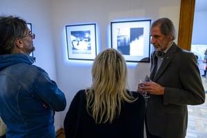 Wystawa: Zamyślniki i inne znaki przestankowe - Publiczność oglądająca fotografie na wystawie i dyskutująca z autorem.