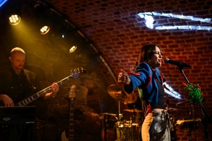 Koncert: Ania Szlagowska - Wokalistka Ania Szlagowska występuje z zespołem muzycznym podczas koncertu.